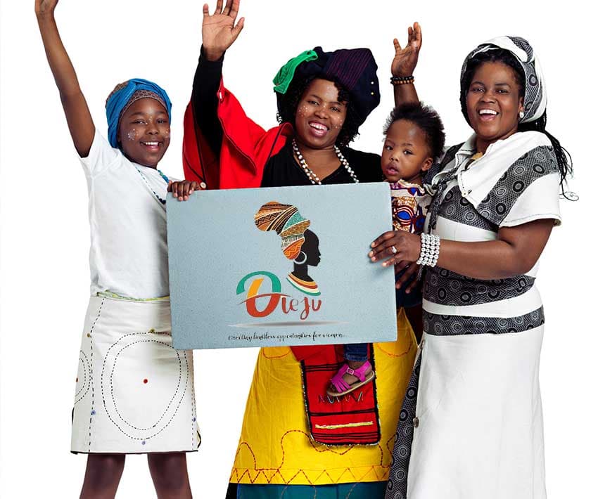 2 women and kids holding an Oleju banner
